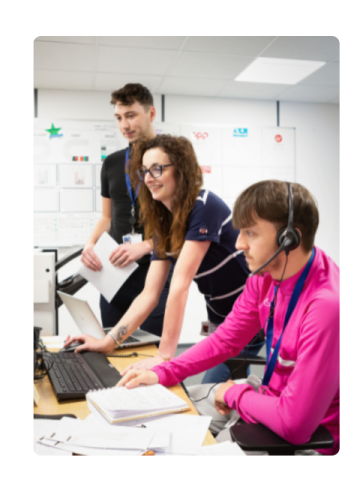 a couple of people looking a computer